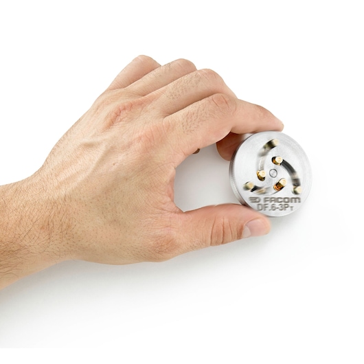 A hand holding a round metallic Facom DF.6-3Pt tool part, with three visible screws arranged in a triangular pattern, on a white background.
