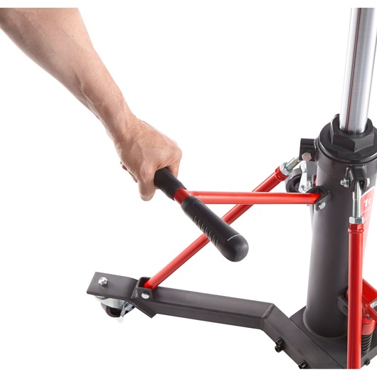 Facom DL1000 hydraulic jack with red handle and black base, side angle, hand operating handle.