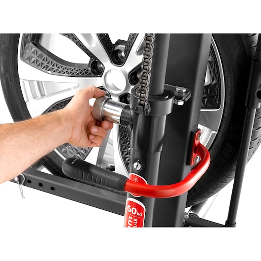 Facom DL_LR car wheel lift with hand adjusting a locking pin, close-up side angle.