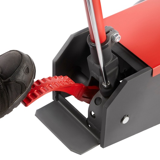 Facom DLPL10A photography of close-up foot pressing red pedal on black and red equipment, angled view.