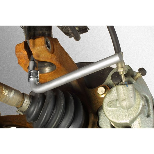 Facom DS_J5 brake bleeder wrench in use on a vehicle's brake caliper, close-up showing tool on bleeder valve.