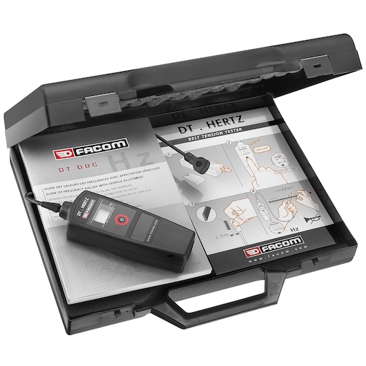 Facom DT_HERTZ belt tension tester kit, shown in a black carrying case with instruction manuals and a digital measuring device.