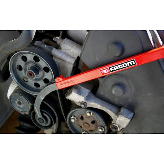 Photo of Facom DT_TWA automotive belt tool in use on an engine pulley.