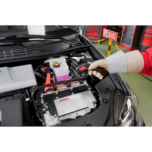 Photo of Facom DX_T100PB tester tool being used to inspect car engine compartment.