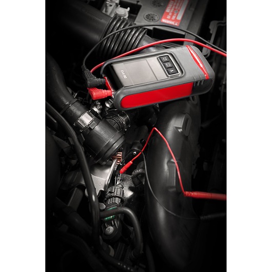 Facom DX.V12PB automotive diagnostic tool with red and black design connected to car engine components.
