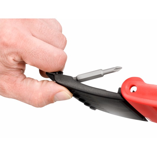 Facom E612PB screwdriver bit set close-up, hand removing bit from red and black holder, white background.