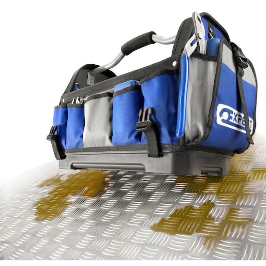 Facom E010601 tool bag with blue and grey fabric, multiple outer pockets, and sturdy handle, shown on metal surface.