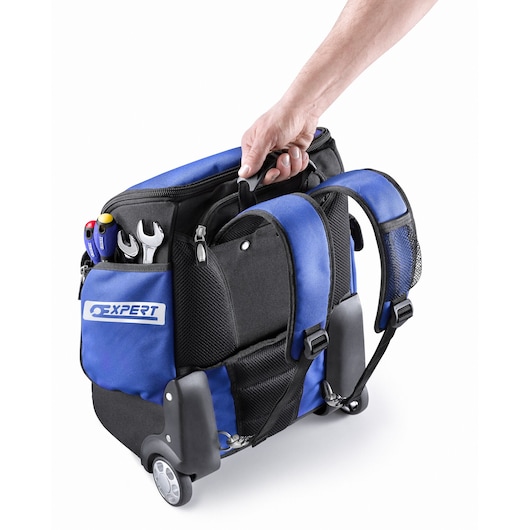 Facom E010602 backpack-style tool bag with wheels, blue and black, side pocket holding tools, rear angle.