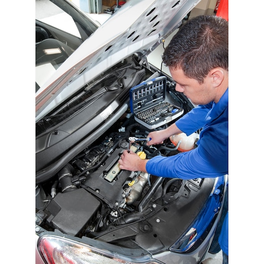 Facom E030707 photography of mechanic using socket set on car engine.