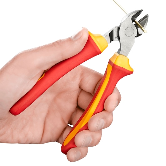 A hand using a pair of red and yellow-handled diagonal cutting pliers to cut a thin wire.