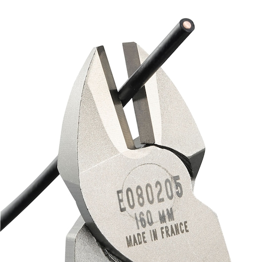 Facom diagonal cutting pliers E080205 close-up, cutting black wire, on white background.