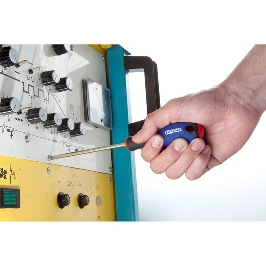 Facom E160101 screwdriver used on an electronic device, close-up of hand holding tool.