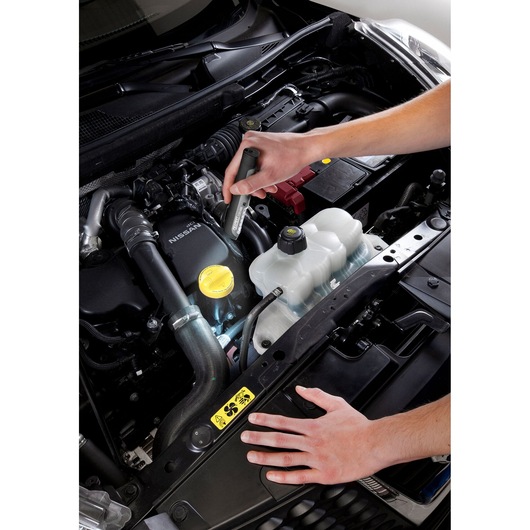 Facom E201406 inspection tool in use on car engine, photography showing tool held above open engine bay.