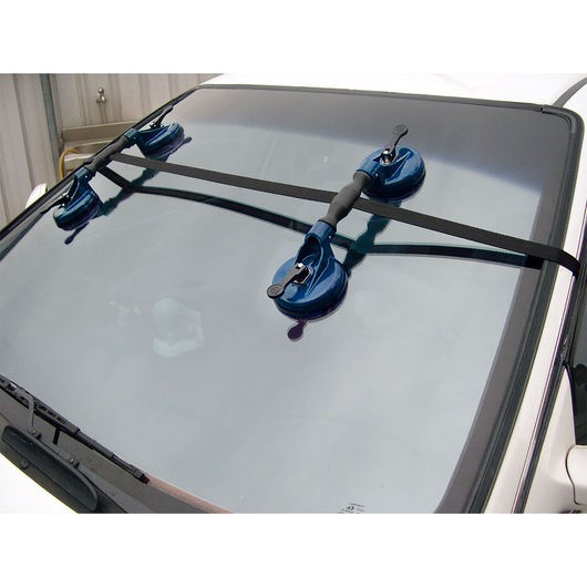 Facom E201501 windshield removal tool with three blue suction cups mounted on a car windshield.