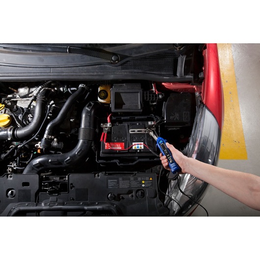 Facom E201806 automotive tester checking a car battery under hood, close-up, photography