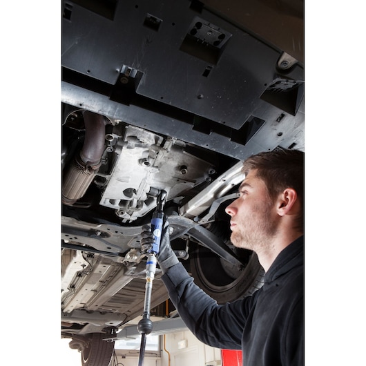 Photo of Facom E230204 tool used by mechanic under car for automotive repair.