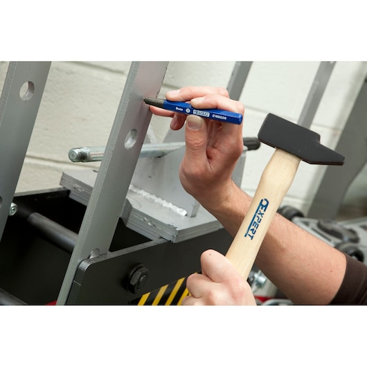 Facom E418228 blue punch and hammer marking a metal beam, close-up angle