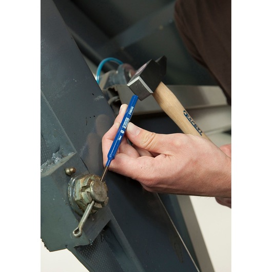Facom E418234 blue punch tool being used with hammer on metal machinery.