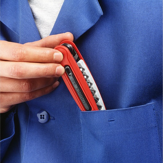 Photo of Facom EFPZ red multi-tool being placed in a blue work jacket pocket.