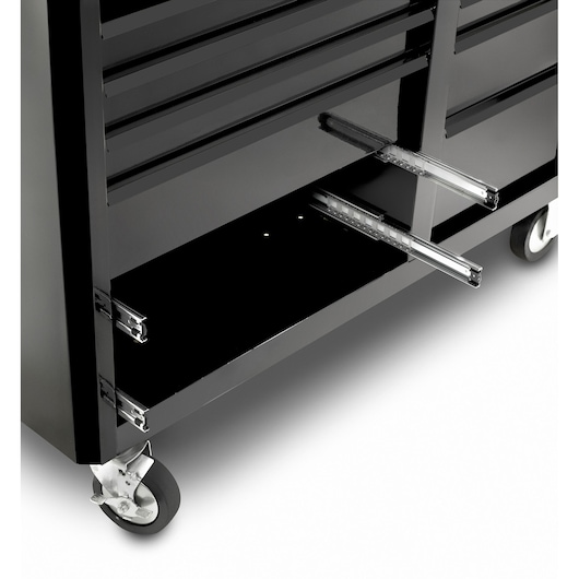Facom FAS_21BK black tool chest photography, close-up of lower drawer slides and caster wheel, angled view.
