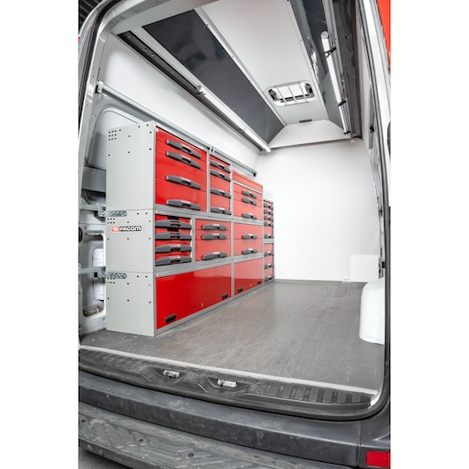 View inside a van equipped with Facom modular storage units featuring red drawers and multiple compartments for organizing tools.