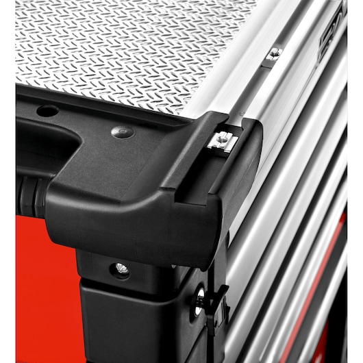 Facom JET.6M3A tool trolley corner detail with black plastic handle and silver diamond plate top, angled view.