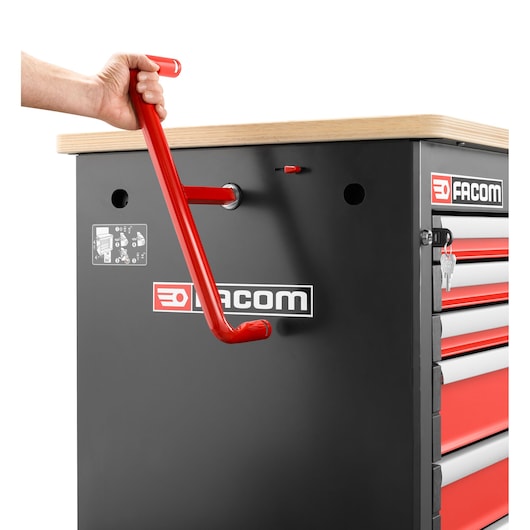 Facom JET.6MWBA tool chest with red handle being attached, black and red drawers, side angle, white background.