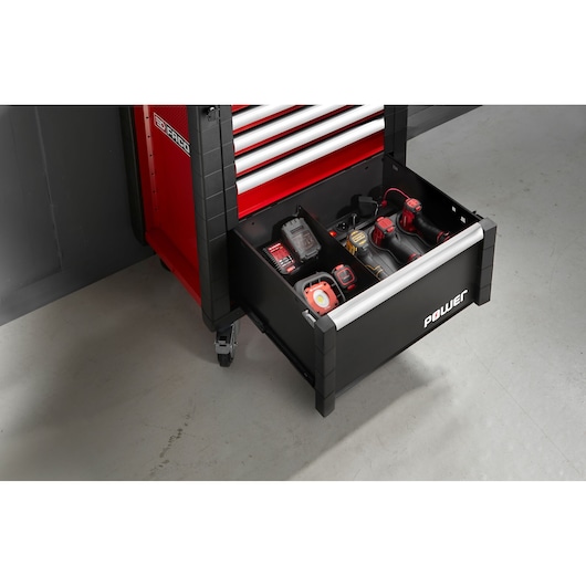 Facom JLS3-MBSPOWER tool cabinet open drawer with assorted power tools, red and black, angled view.