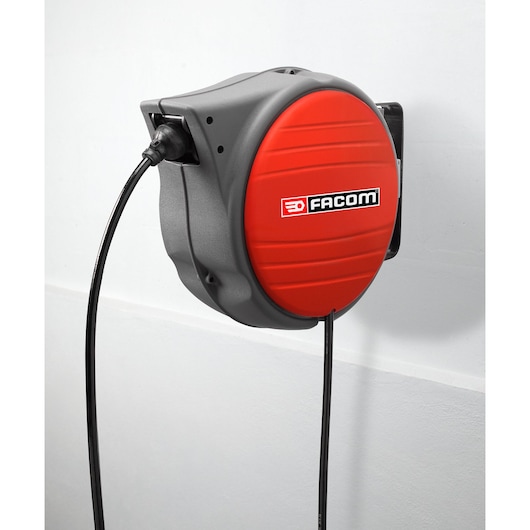 Photo of Facom wall-mounted retractable cable reel, red and grey, side angle, SKU N_709.