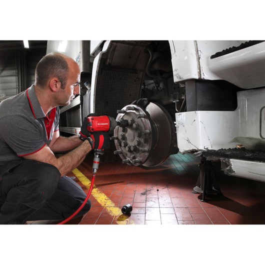 Facom NK.3000FPB impact wrench used by technician on vehicle wheel in workshop setting