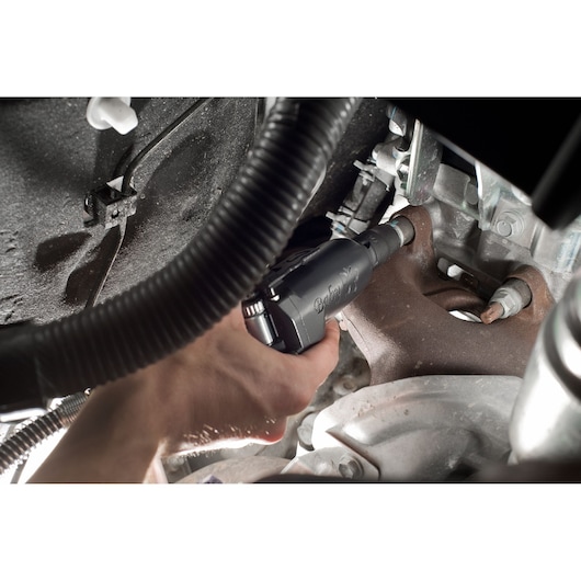 Facom NS.1400FPB pneumatic tool in use tightening a bolt on automotive engine part.