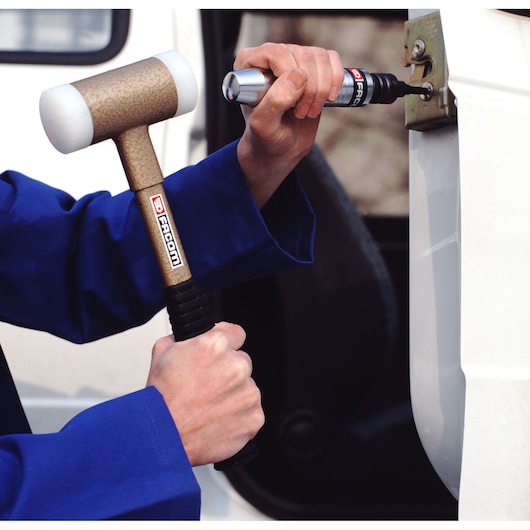 Photo of Facom NS260A impact screwdriver used with a Facom mallet to loosen a vehicle door hinge.