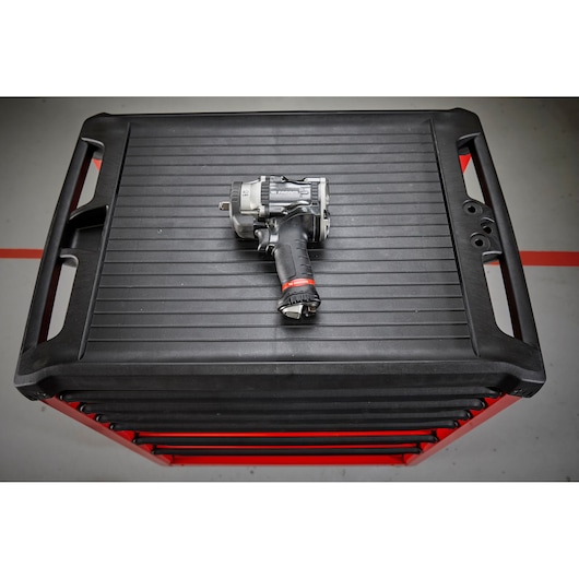 Facom NS.3500GPB impact wrench on top of a black tool chest, overhead angle.