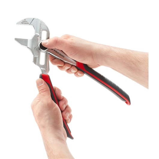 Facom PWF250CPEPB pliers with black and red handles held in hands, front angle, photography