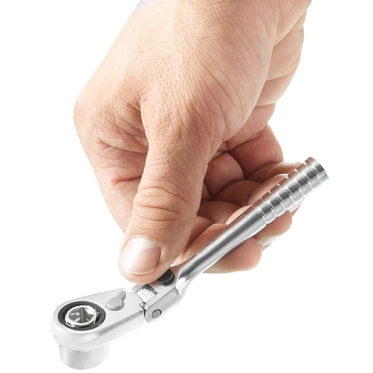 Photo of a hand holding a Facom R_180HX mini ratchet wrench, silver finish, on white background.