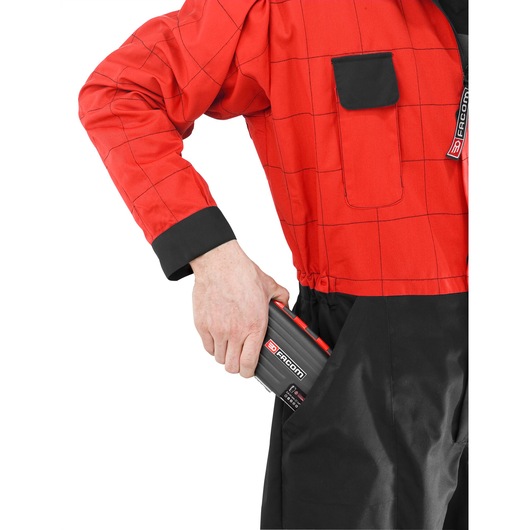 Photo of Facom R_360NANO compact tool case being placed in black pocket, partial view, white background.