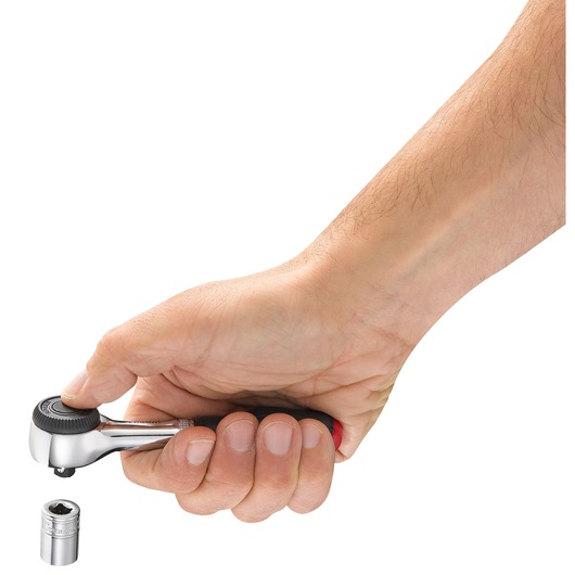 Facom R_360 ratchet wrench in hand on white background, socket being ejected below tool.