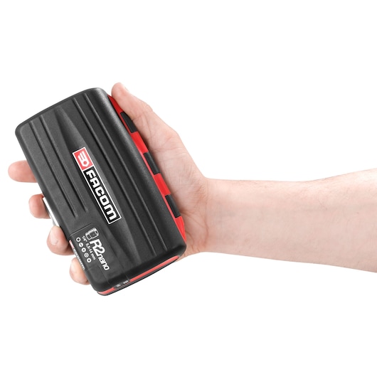 A hand holding a Facom R2Nano black and red electronic device with the logo and product name clearly visible.