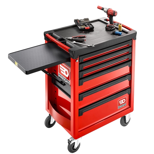 Facom ROLL.6M3APB red rolling tool cabinet with side tray, four drawers, tools and drill on top, studio angle.