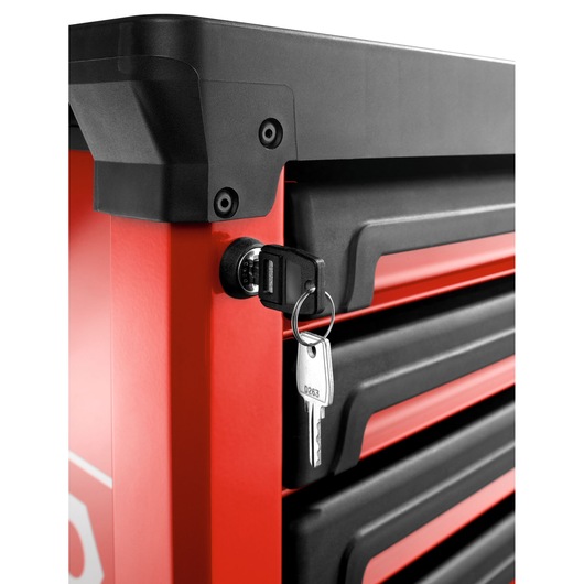 Photo of Facom ROLL.6M3APB tool chest corner with lock and key in close-up, black and red drawers, angled view.