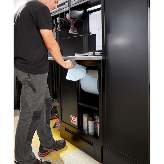 Photo of Facom RWS2-MBSERBS workshop cabinet with black finish, showing paper roll dispenser and storage shelves.