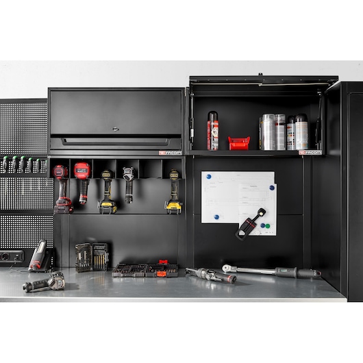 Facom RWS2-POWRACKBS black metal wall storage system with open compartments, tools, and accessories, straight angle.