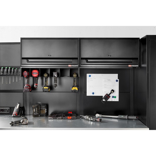 Facom RWS2-POWRACKBS black tool storage rack with power tool holders and workspace, front angle.