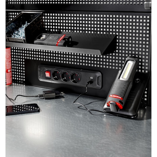 Facom RWS2-PPAV1USBBS workbench power strip with USB and tools on metal surface, front angle.