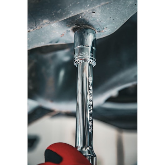 Facom S.17GRP socket wrench in use under metal surface, close-up photography, visible chrome finish.