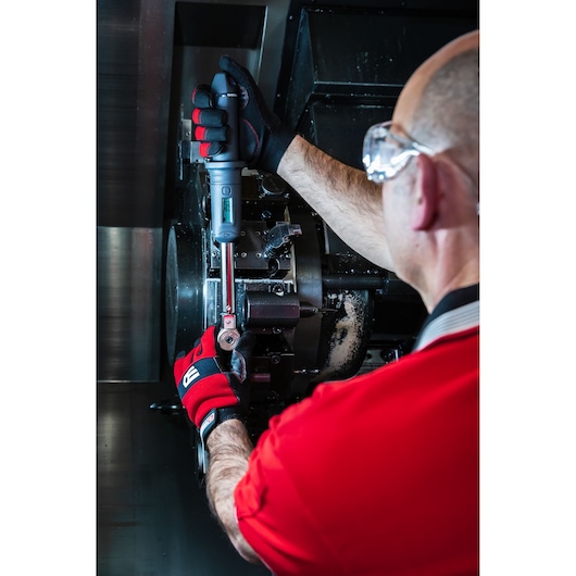 Facom S.307A340 torque wrench used by technician in industrial machinery, red gloves, close-up.