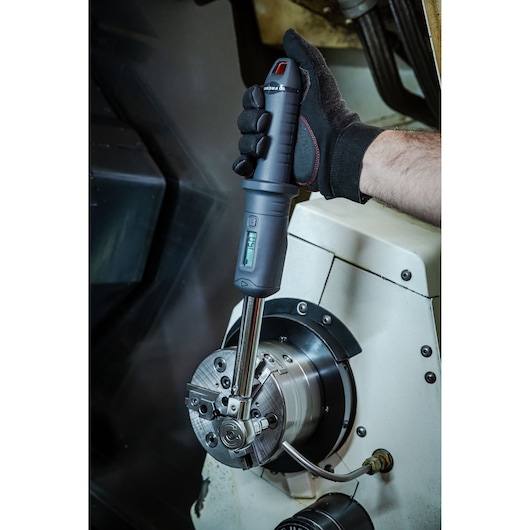 Facom S.307A340 digital torque wrench in use on industrial machinery, close-up view.