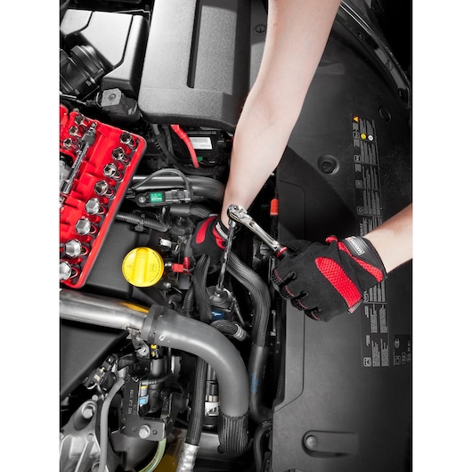 Facom SL_171 ratchet wrench set used for car engine repair, mechanic with gloves, top view.