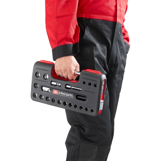 Photo of Facom SL.DBOX112PB socket set in black and red carrying case held by person in black and red workwear.