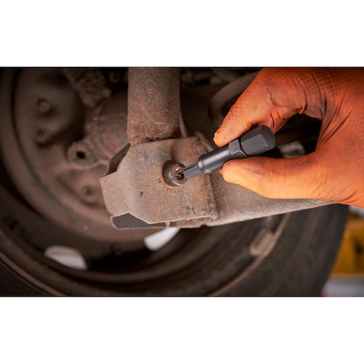Photo of Facom bit being used to unscrew a rusted bolt on a car part, SKU SXE_J7MGRPPB.